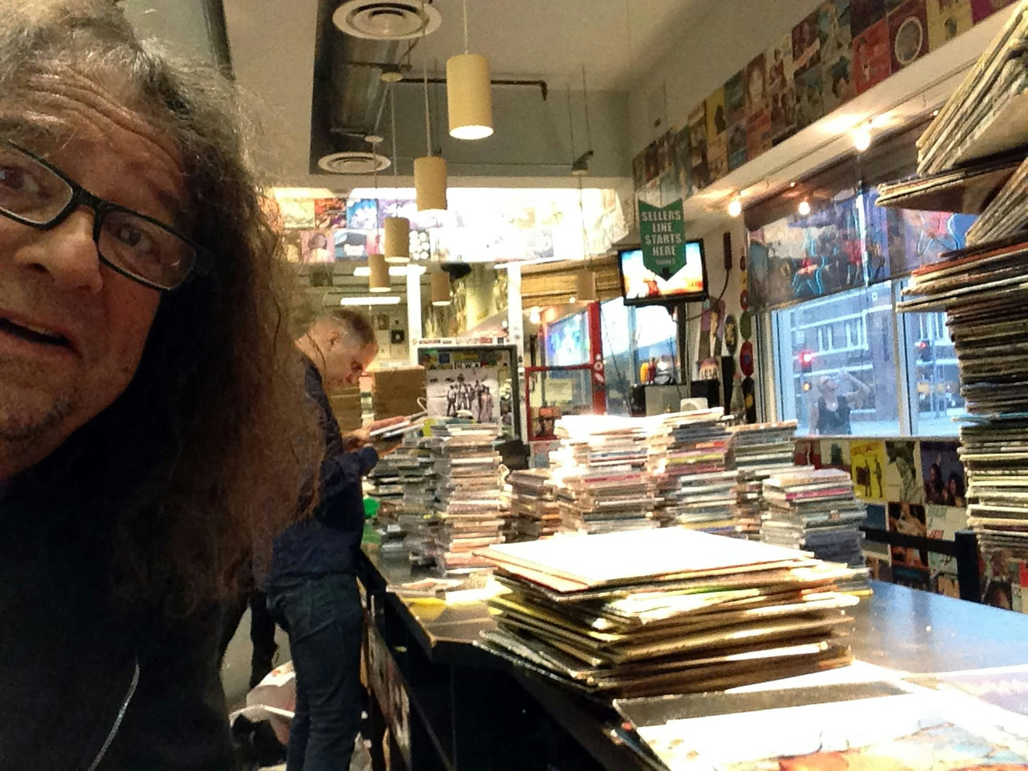 Weinstein on a typical day at Amoeba L.A. at the non-stop buying counter.
